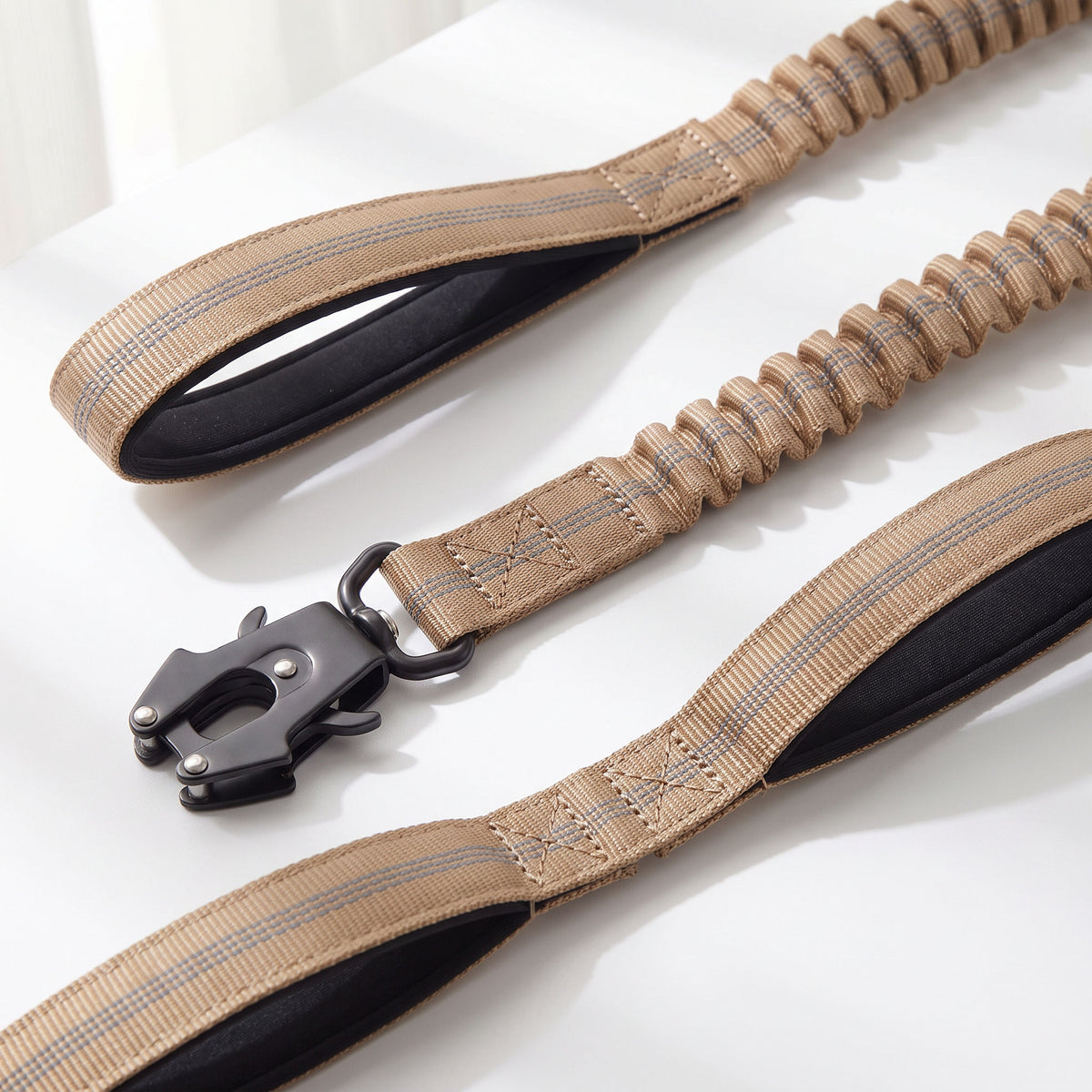 Macro of the X-shaped reinforcement stitching where the webbing folds back around the metal clip