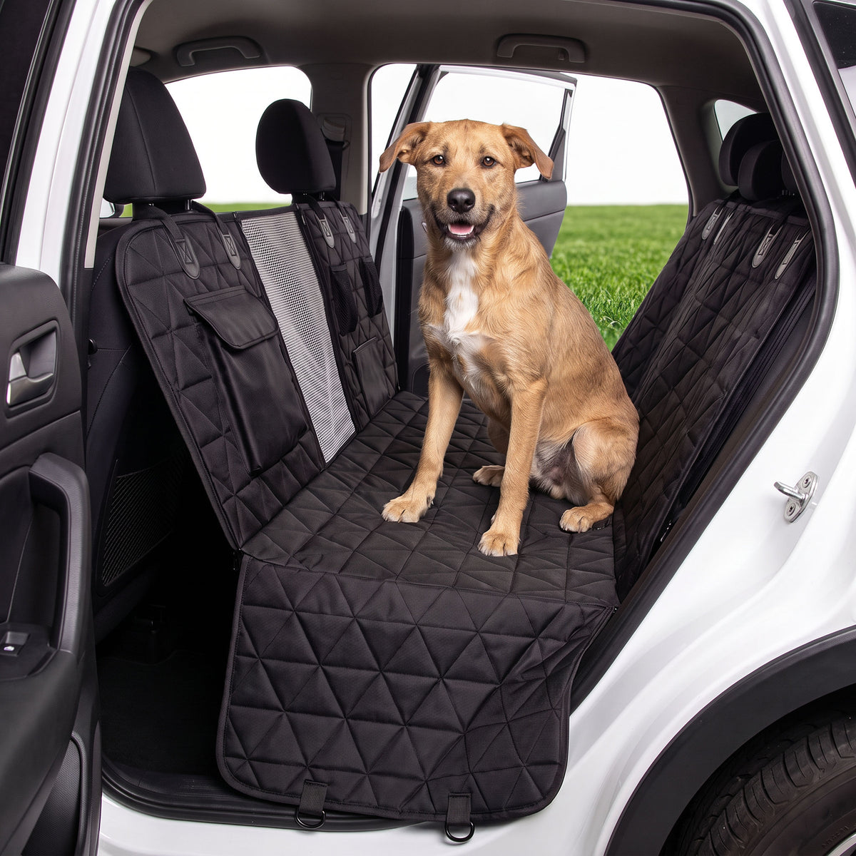 Dog car seat cover laid out on green grass outdoors
