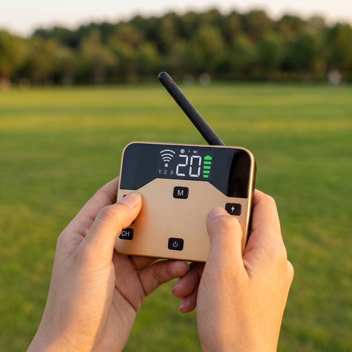 Thumb changing the boundary level on the handheld transmitter with the lawn behind