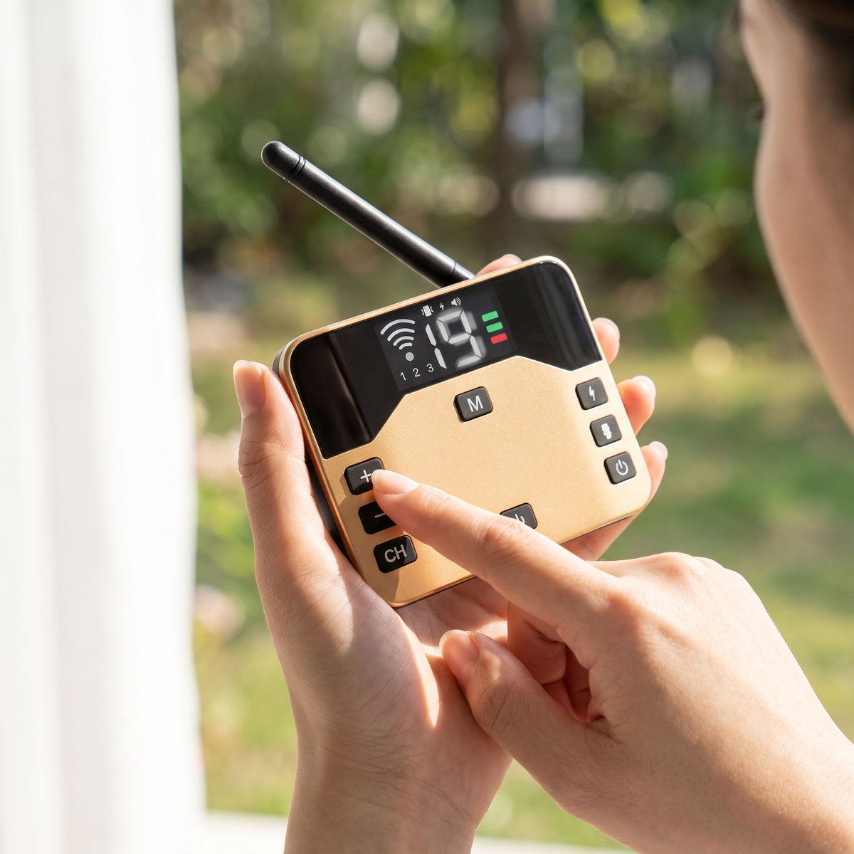 Hands setting the correction level on the handheld transmitter