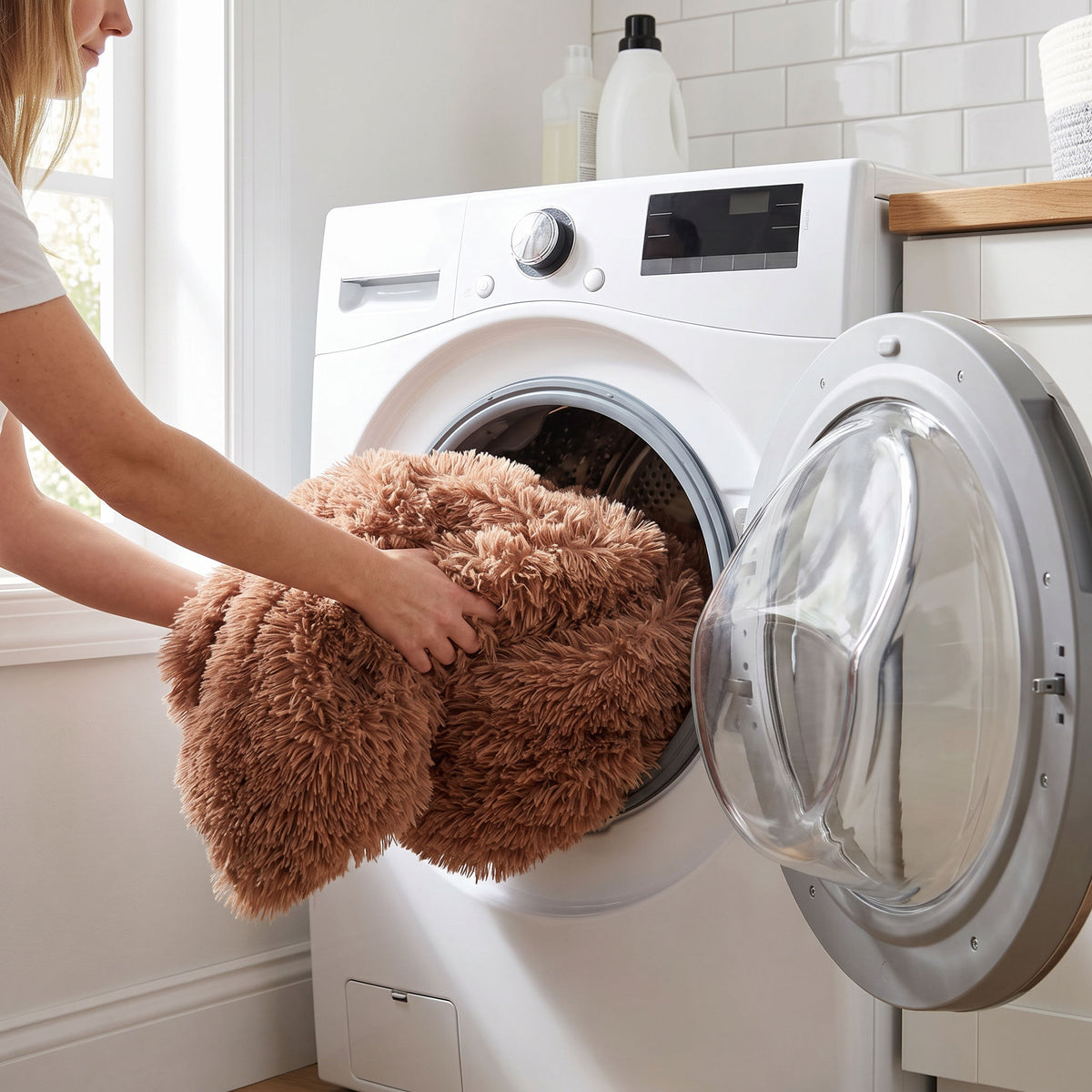 Removable plush cover being loaded into a front-loading washing machine