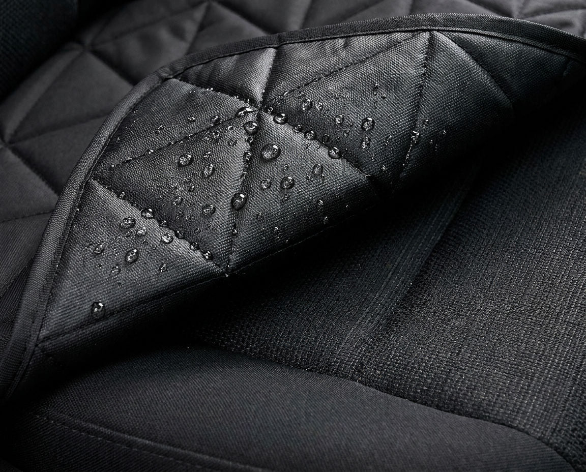 Underside of the car seat cover folded back against the seat upholstery